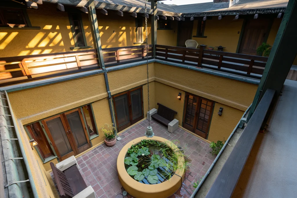 Second-floor view of The Duncan-Irwin House central courtyard with lattice-work and fountain below.
