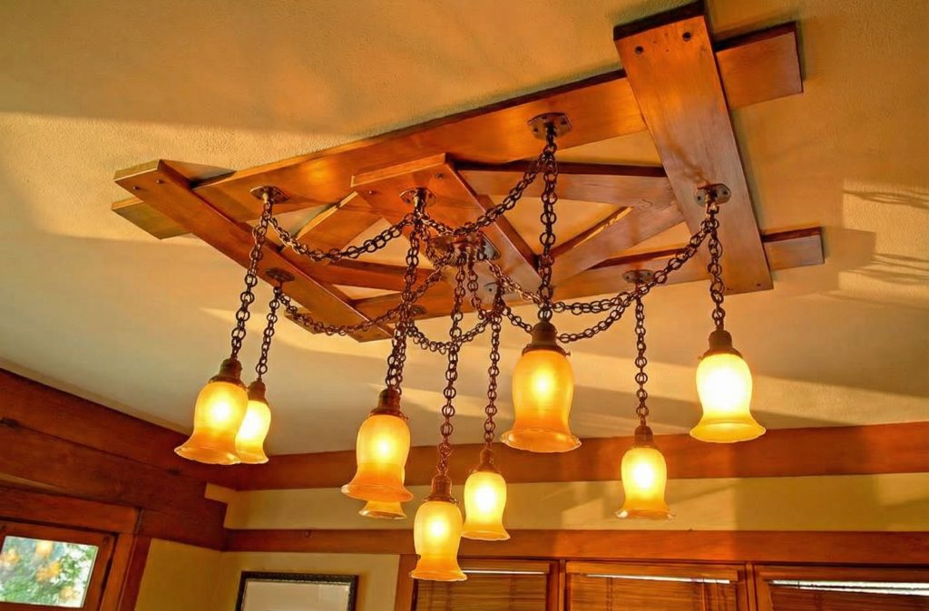 A close-up of the dining room light fixture in The Caroline S. de Forest House, a masterpiece of metalwork and glass.