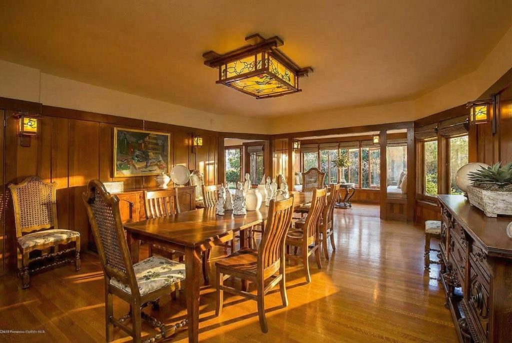 Dining room at The Dr. William T. Bolton House #3 featuring multi-bulb light fixture and Grueby tile fireplace.