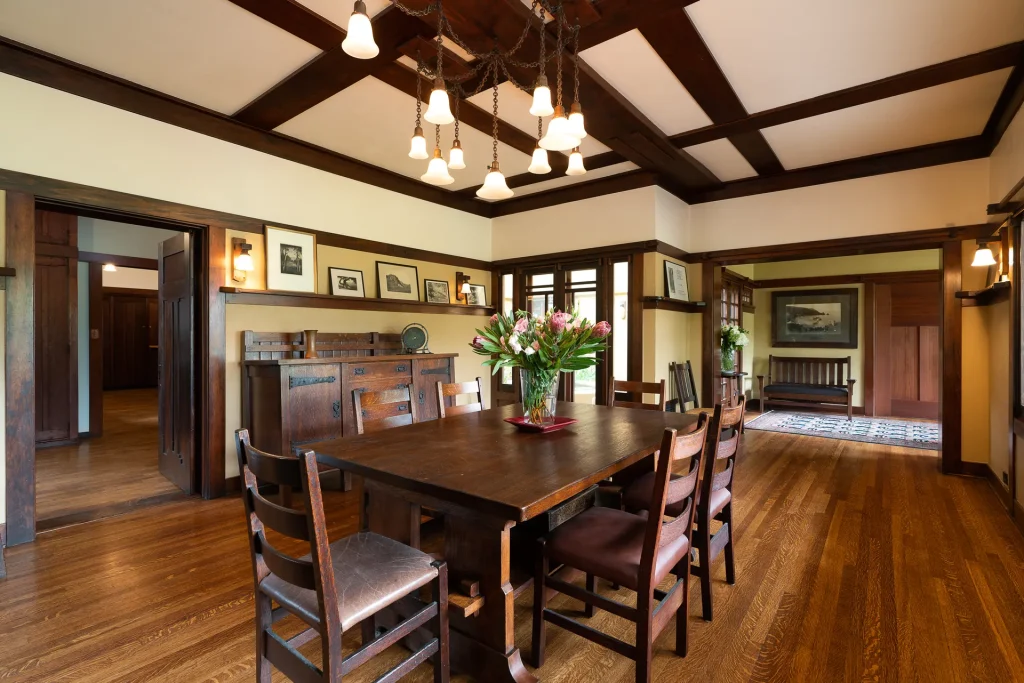 Alternate view of The Duncan-Irwin House dining room showcasing wood paneling and craftsman details.