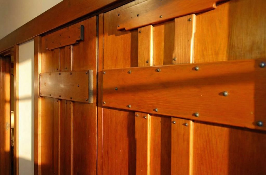 A detail shot of a wooden door in The Caroline S. de Forest House, showing the fine joinery and craftsmanship of the hardware.