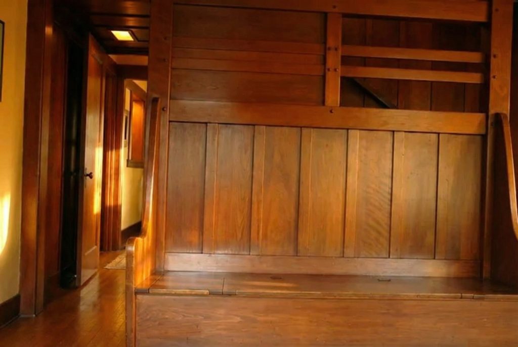 Built-in entry hall bench at The Mary L. Ranney House showcasing Greene & Greene joinery and cloud lift brackets.