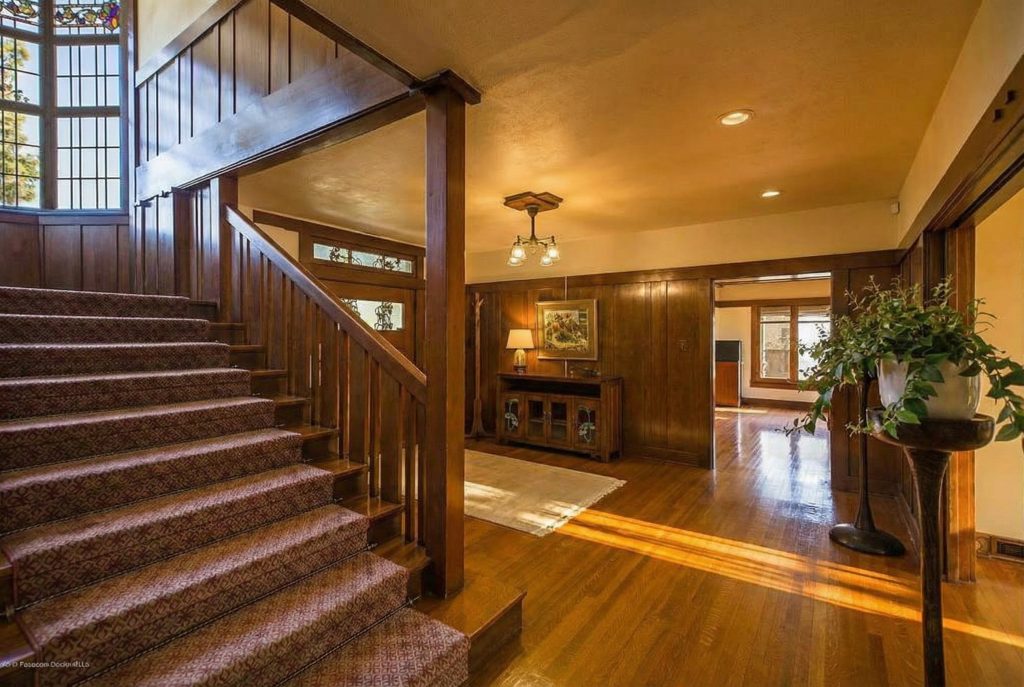 Alternate view of the entry hall at The Dr. William T. Bolton House #3 with rich wood paneling.
