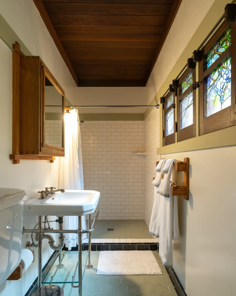 First-floor bedroom bathroom in The Duncan-Irwin House with vintage tile and restored fixtures.
