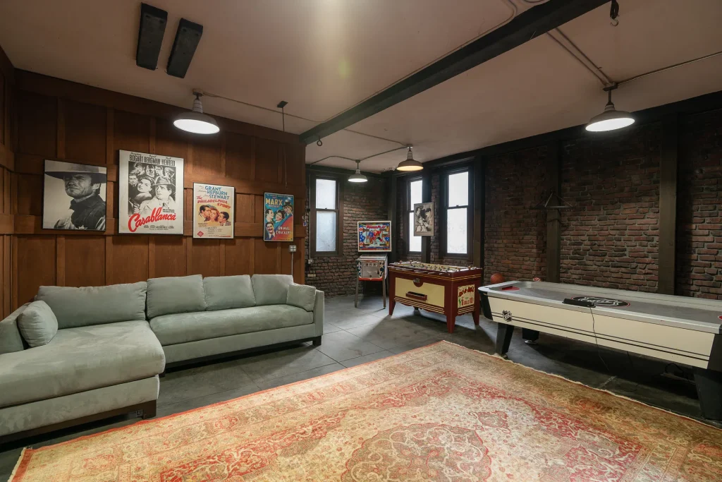 The Duncan-Irwin House garage game room with exposed timber beams and recreational space.