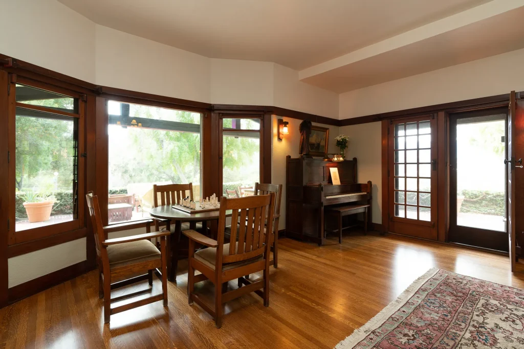 Sitting area within The Duncan-Irwin House great room featuring craftsman furniture and natural light.