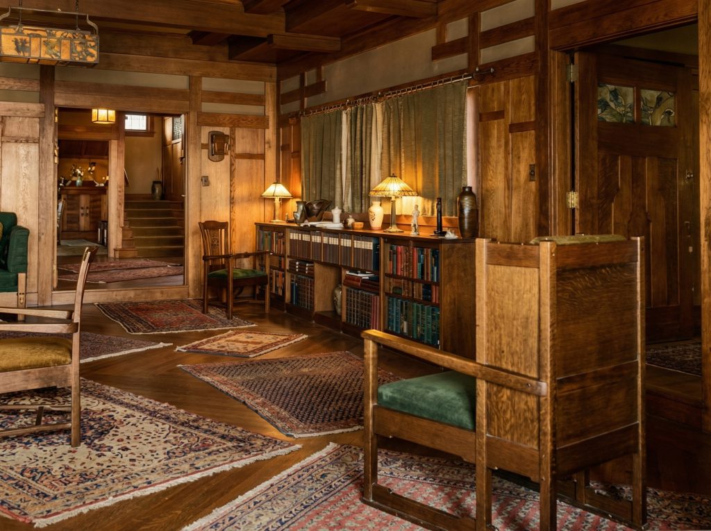 Historic colorized photograph of the interior of the Freeman A. Ford House, showing original woodwork and furnishings.