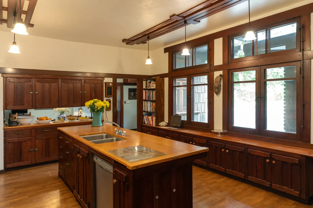 Alternate view of The Duncan-Irwin House kitchen showcasing open layout and craftsman cabinetry.