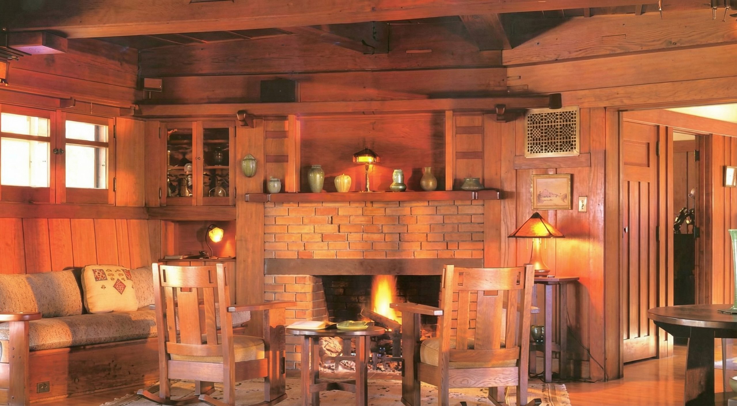 Living room of the Charles M. Pratt house glowing with warm light, photographed by Alexander Vertikoff