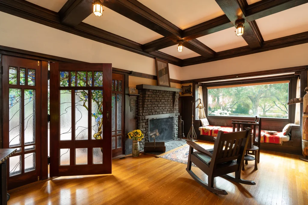 The Duncan-Irwin House living room with Stickley furniture, tile fireplace, and cascading light fixture.