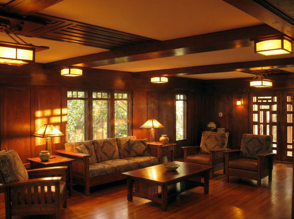 Living room interior of the John Bakewell Phillips House displaying Arts and Crafts woodwork and period furnishings.