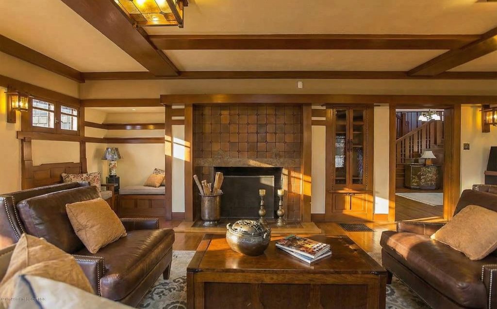 Living room fireplace at The Dr. William T. Bolton House #3 with restored Grueby tile surround.