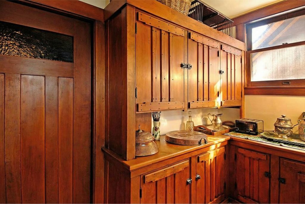 The pantry of The Caroline S. de Forest House, with its original wooden shelving and cabinetry, showcasing the beauty of utility.