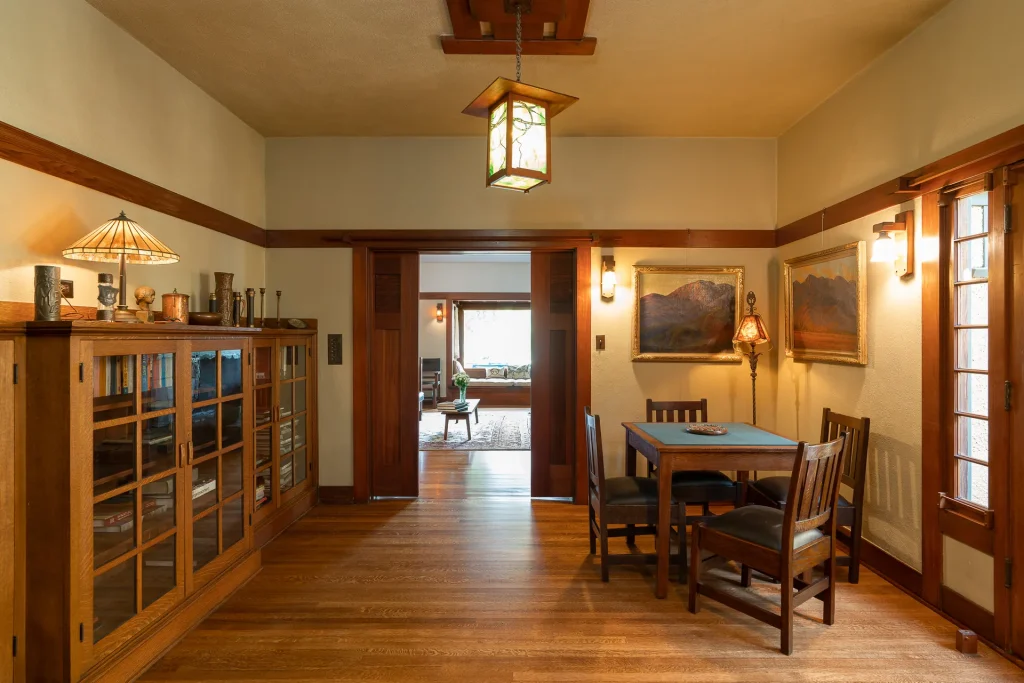 Intimate sitting area in The Duncan-Irwin House with period furnishings and wood-paneled walls.