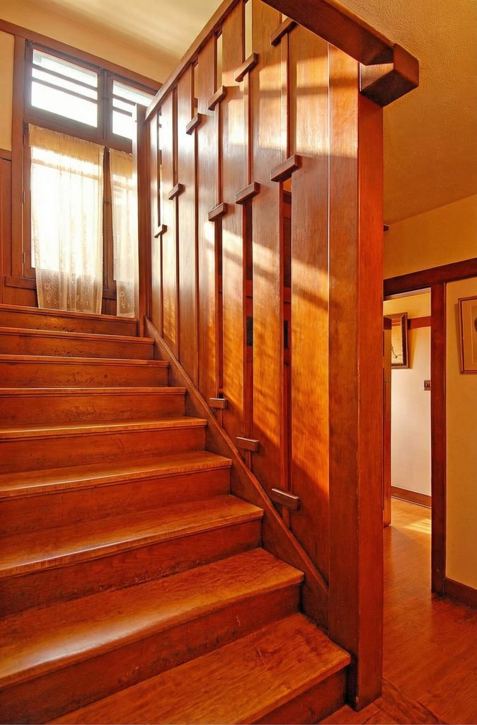 An alternate view of the staircase in The Caroline S. de Forest House, showing its elegant design and integration with the entry hall.