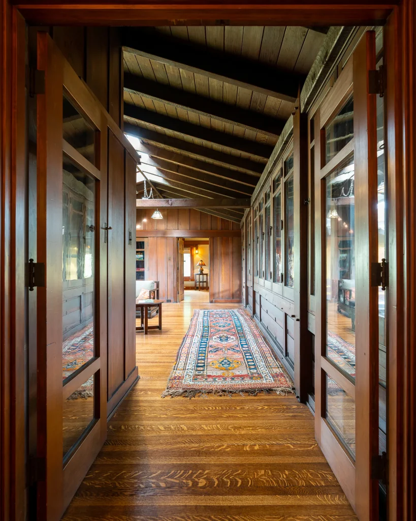 Upstairs living room of The Duncan-Irwin House with log cabin-like sitting area and fireplace.