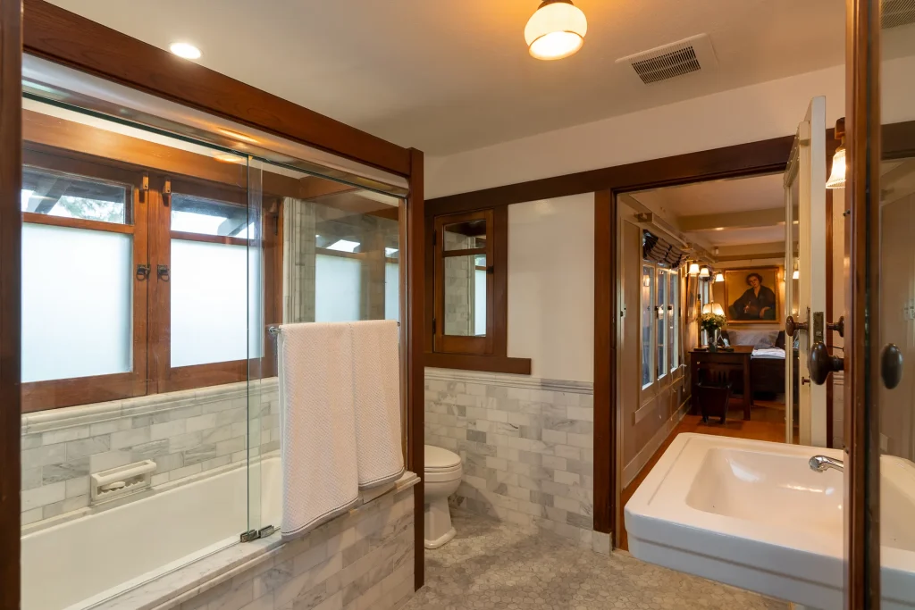 Alternate view of The Duncan-Irwin House master bathroom showcasing vintage tile and classic design.