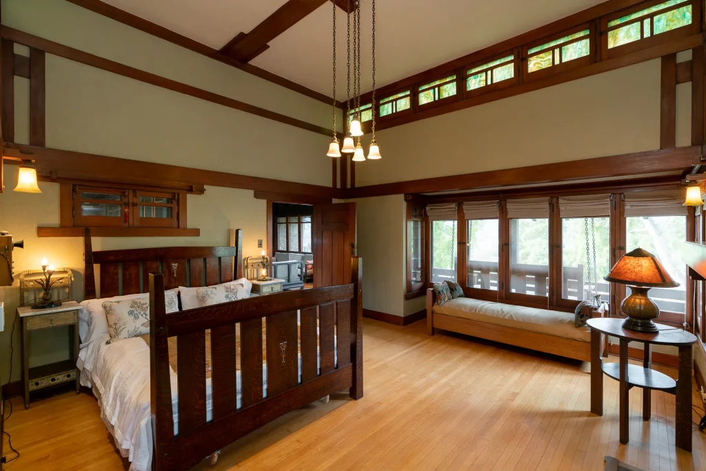 The Duncan-Irwin House master bedroom with raised ceiling, fireplace, and balcony access.