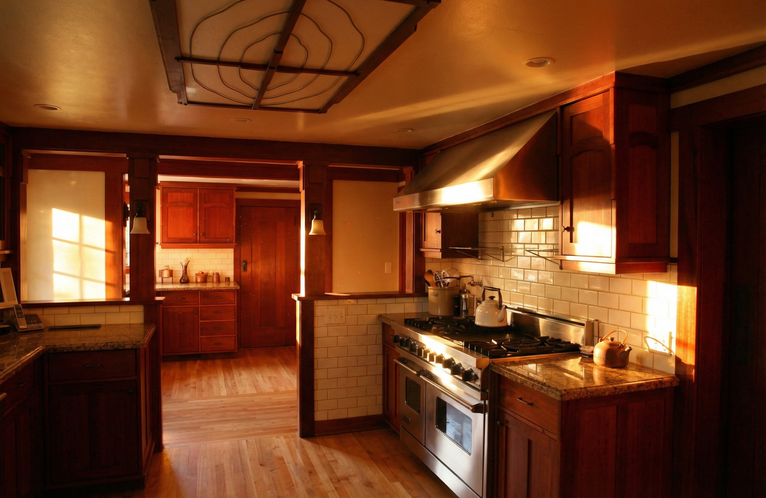 Contemporary kitchen interior of the van Rossem-Neil House showing exposed ceiling beams, rich wood cabinetry, and modern appliances.