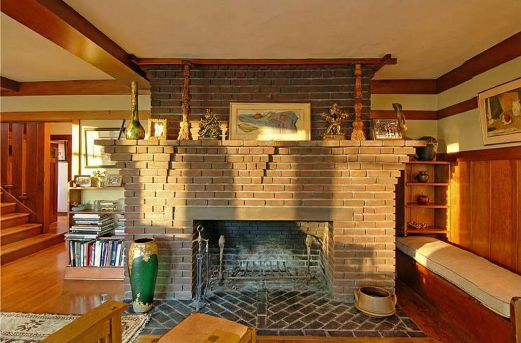 The massive clinker brick fireplace in The Caroline S. de Forest House, with its broad mantelpiece and built-in inglenook.