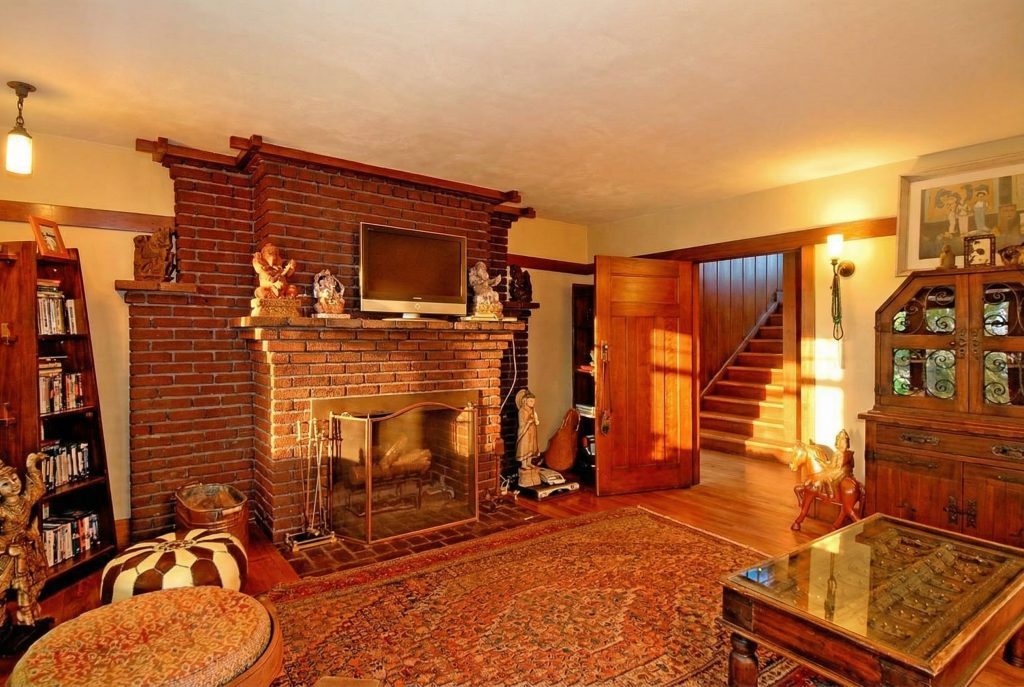 A bedroom fireplace in The Caroline S. de Forest House, with a television discreetly placed above the mantel.