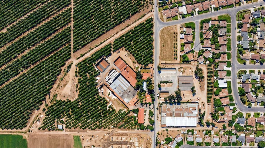 Aerial view of Leffingwell Rancho showing citrus groves meeting suburban development near The Charles W. Leffingwell Bunkhouse site