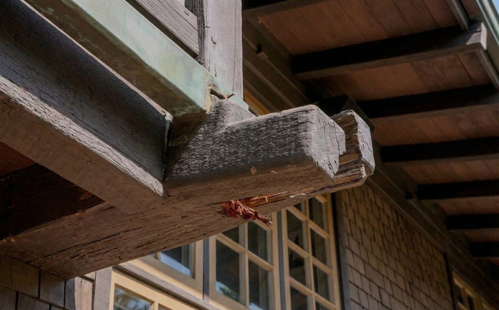 Deck restoration work in progress at the Robert Pitcairn Jr. house showing preserved timber railings and structural details.