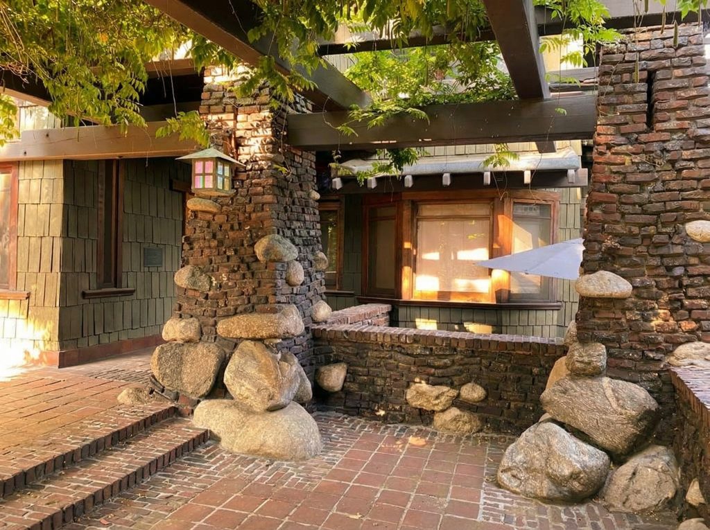 Alternate view under The Duncan-Irwin House pergola revealing brick-and-boulder columns with flared bases.