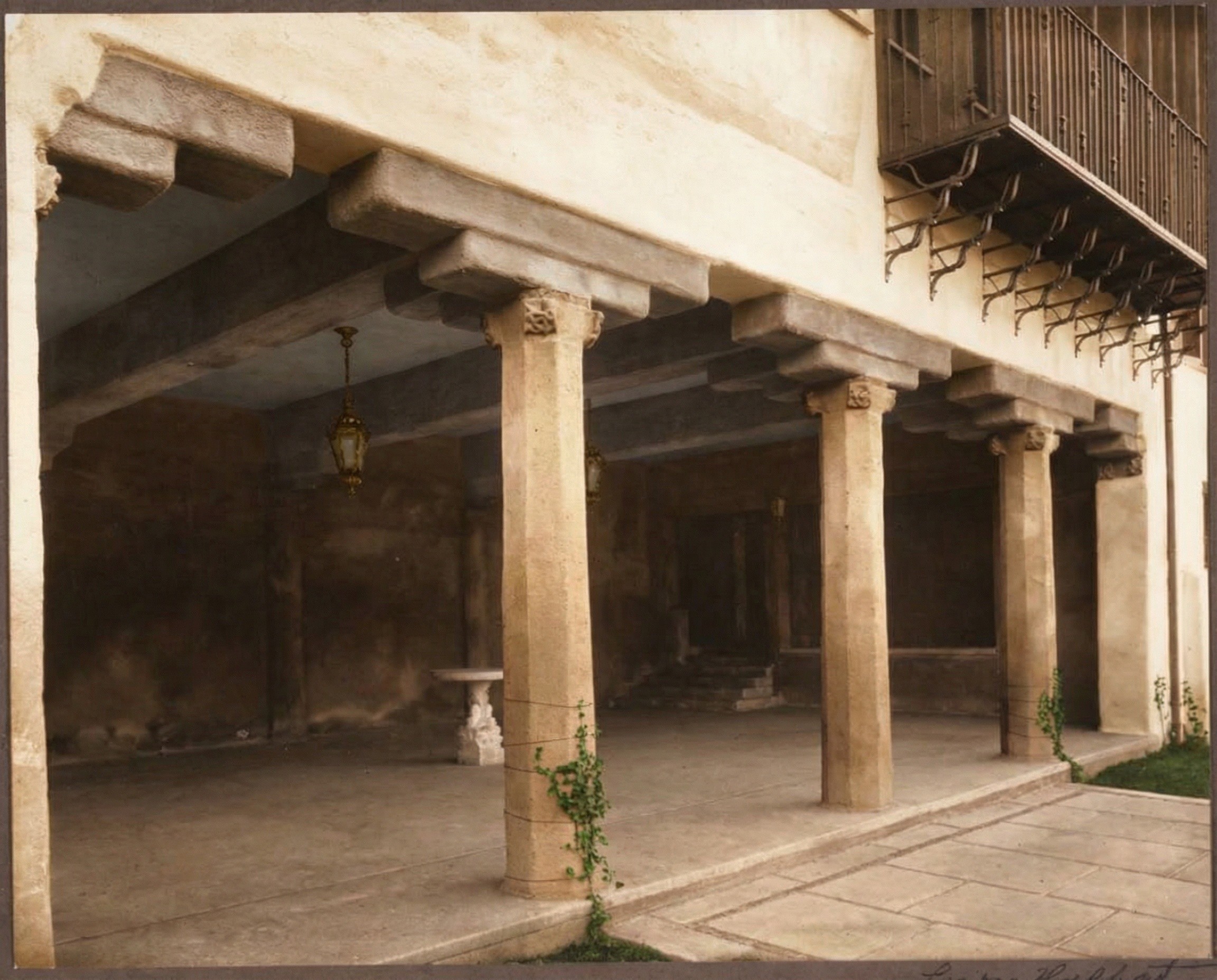 Photograph circa 1915 of the arched loggia of the Cordelia A. Culbertson House facing the central courtyard, with a tiled floor, plastered arches, and columns forming a sheltered outdoor room
