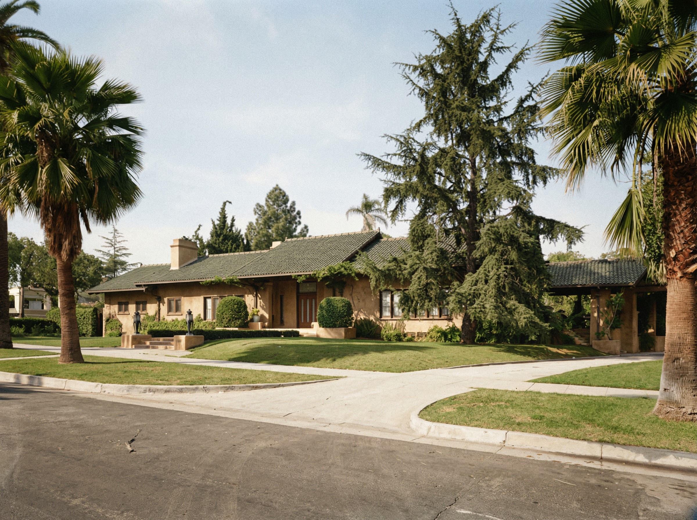 Photograph dated 1947 of the front of the Cordelia A. Culbertson House seen from the street, with mature landscaping and a weathered tile roof