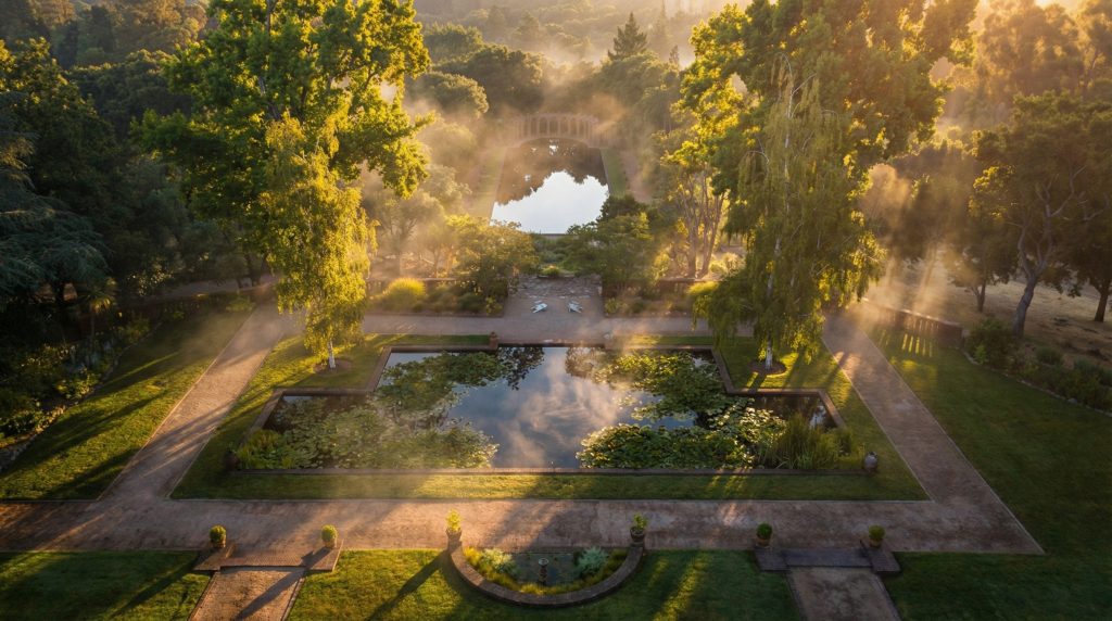 An aerial photo looking south over The Mortimer Fleishhacker Estate, with the lily pond and Roman pool in the foreground.