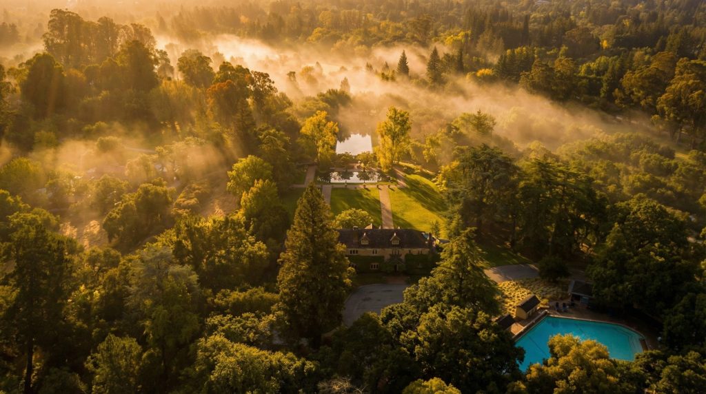 A contemporary aerial photo looking south, showing the main house and extensive grounds of The Mortimer Fleishhacker Estate.