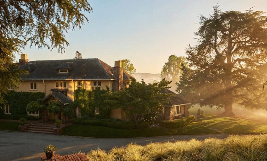 A contemporary photo of the northwest elevation of The Mortimer Fleishhacker Estate, showing its complex rooflines.