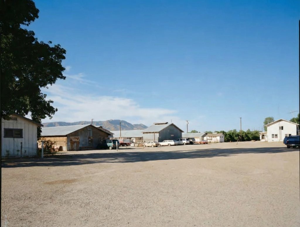 Distant exterior view of the east side of The Sespe Ranch Bunkhouse set against the Santa Clara River Valley landscape