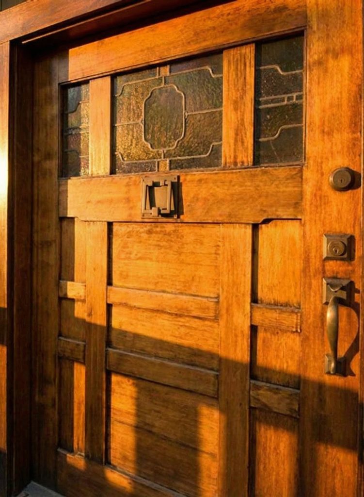 Close-up of the Craftsman-style front entry door and covered porch at The Earle C. Anthony house in Beverly Hills