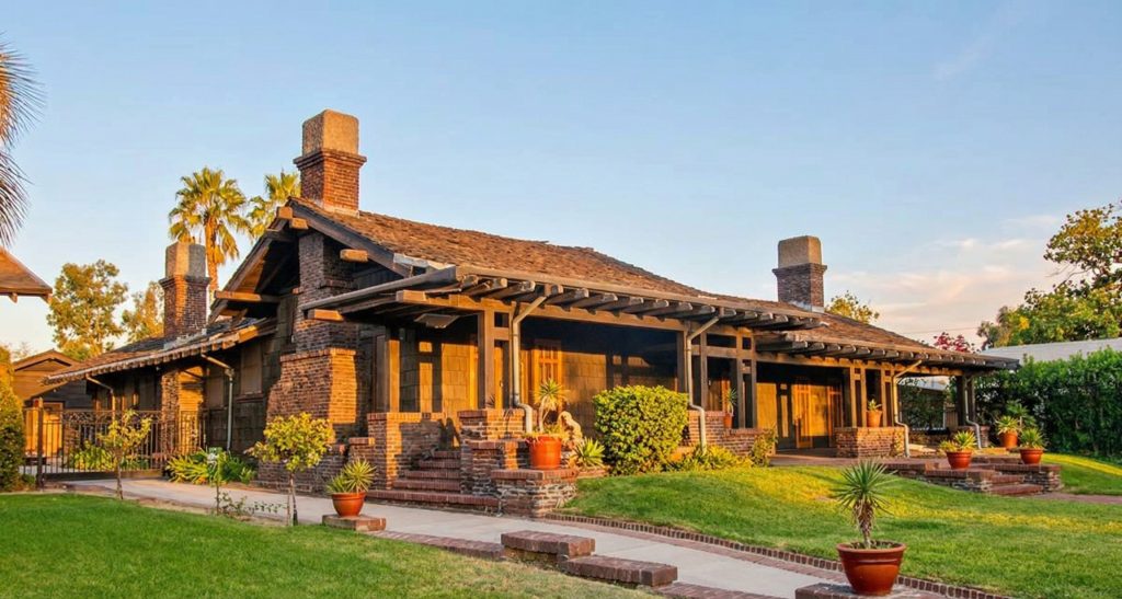 A modern front perspective view of The Dr. S. S. Crow House, showing the mature landscaping and the timeless quality of the Greene & Greene design.