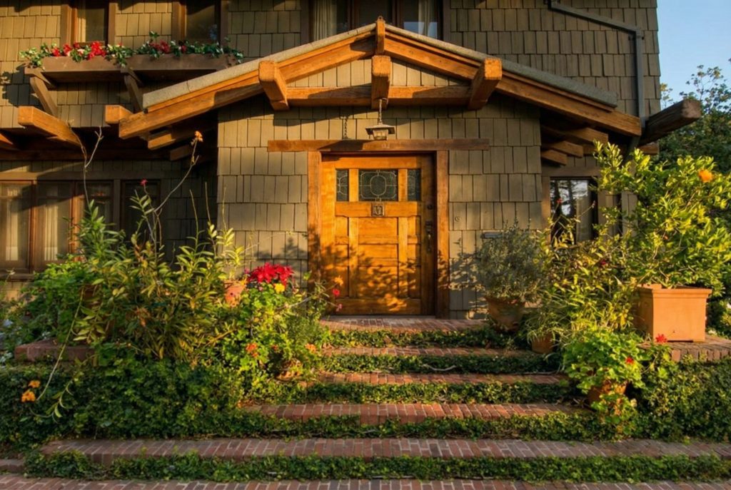 The Earle C. Anthony house front terrace and entry door framed by timber columns and wide overhanging eaves
