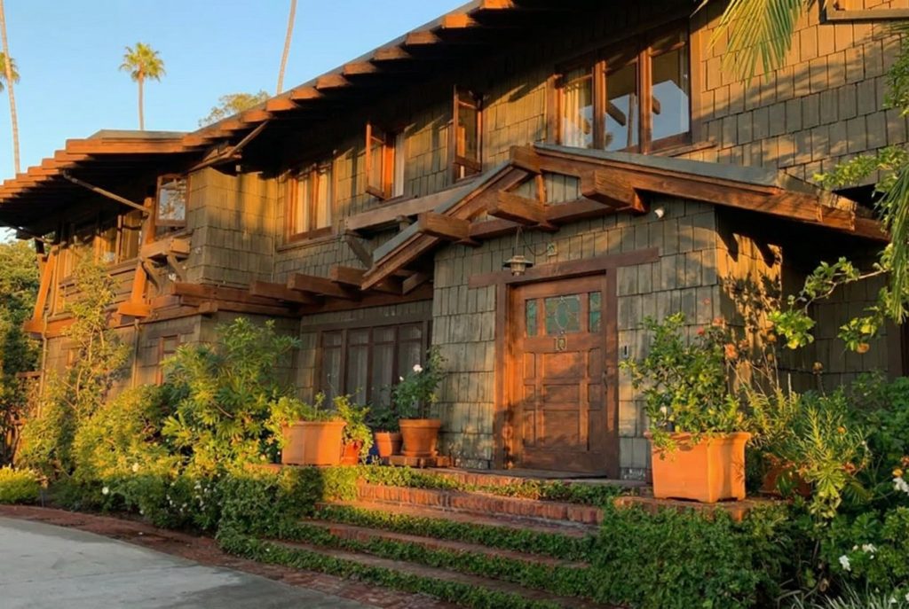 Side view of the front terrace and entry at The Earle C. Anthony house highlighting Greene and Greene timber detailing