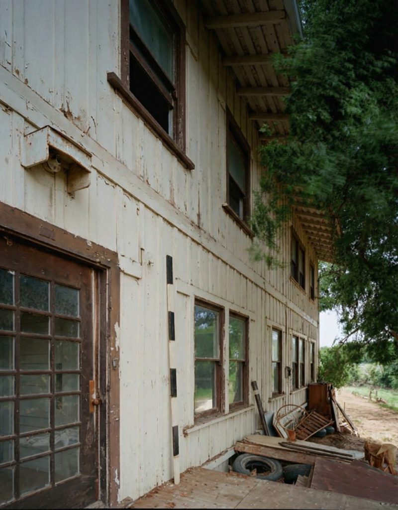 Exterior perspective view of the north entrance of The Sespe Ranch Bunkhouse showing the concrete stoop and main entry facade