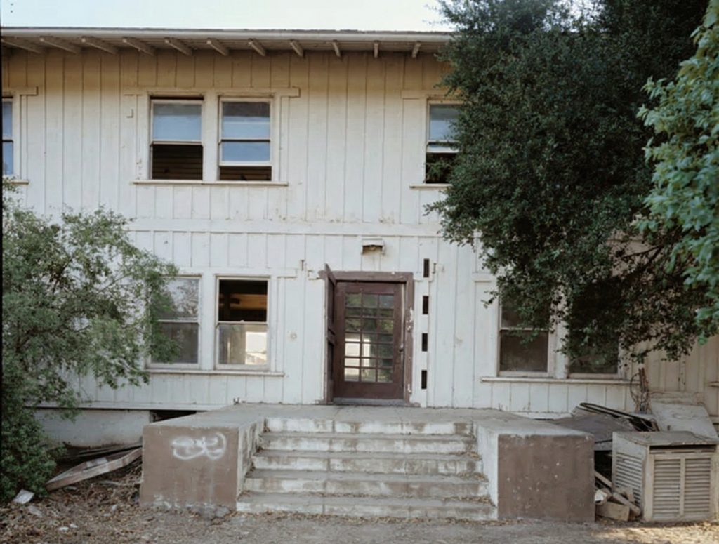 Exterior view of the north entrance steps and door of The Sespe Ranch Bunkhouse highlighting the concrete porch and entryway