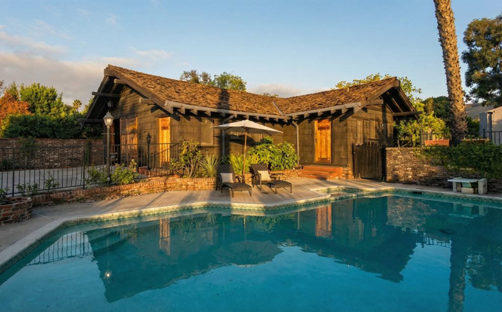 A view of the large garage from the pool area at The Dr. S. S. Crow House, showing the harmonious integration of the estate's various structures.