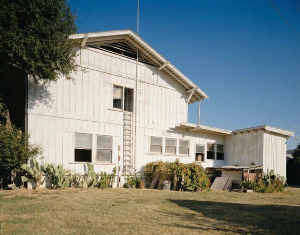 Exterior perspective of the west elevation of The Sespe Ranch Bunkhouse displaying the rear facade and board-and-batten siding