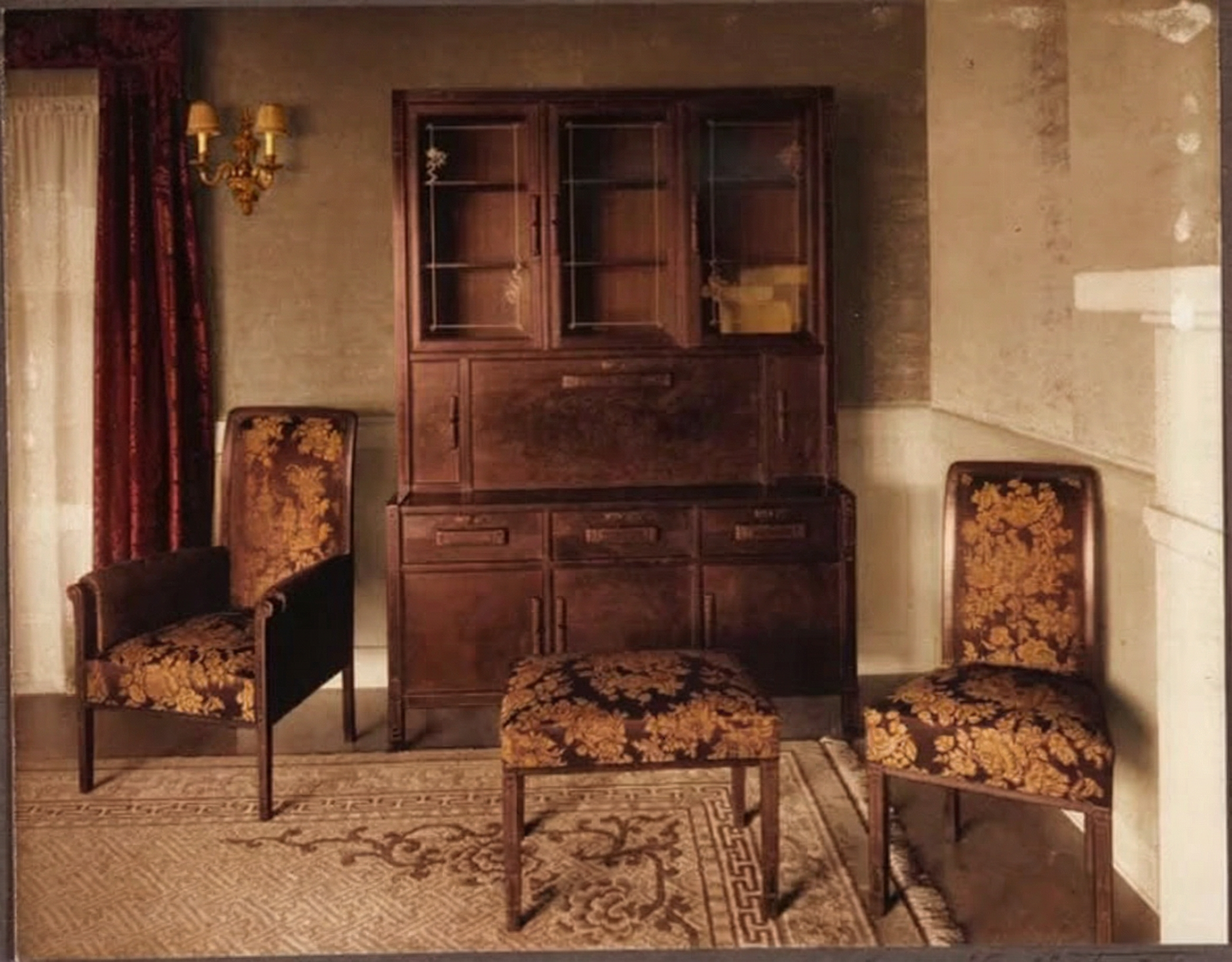Photograph circa 1915 of the living room interior of the Cordelia A. Culbertson House, showing restrained light wood trim, built-in cabinetry, and large windows, lighter and more formal than the firm's earlier bungalow interiors