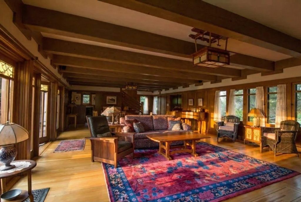 Alternate view of the living room inside The Earle C. Anthony house with beamed ceilings and built-in wood cabinetry