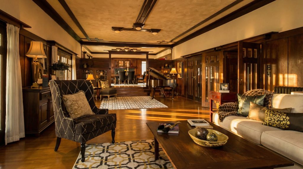A view from the living room into the dining room of The Dr. S. S. Crow House, showcasing the open, flowing connection between the main social spaces.