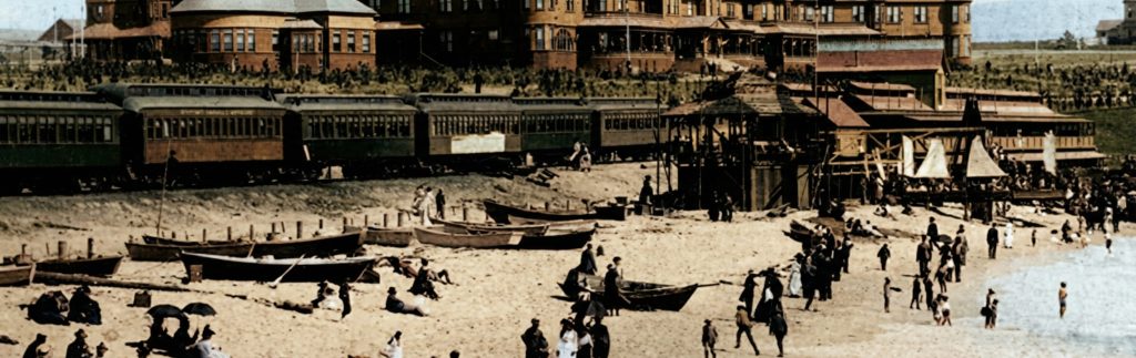 Early 1900s Redondo Beach with Pacific Electric Railway cars, beachgoers, and the Hotel Redondo in the background