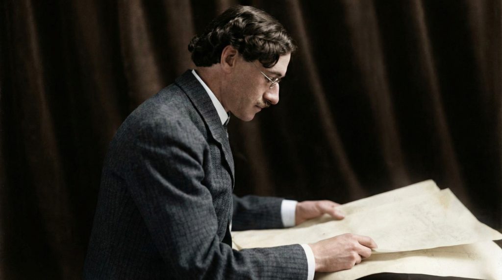 Architect Charles Sumner Greene, the principal designer of The Mortimer Fleishhacker Estate, reviewing architectural plans.