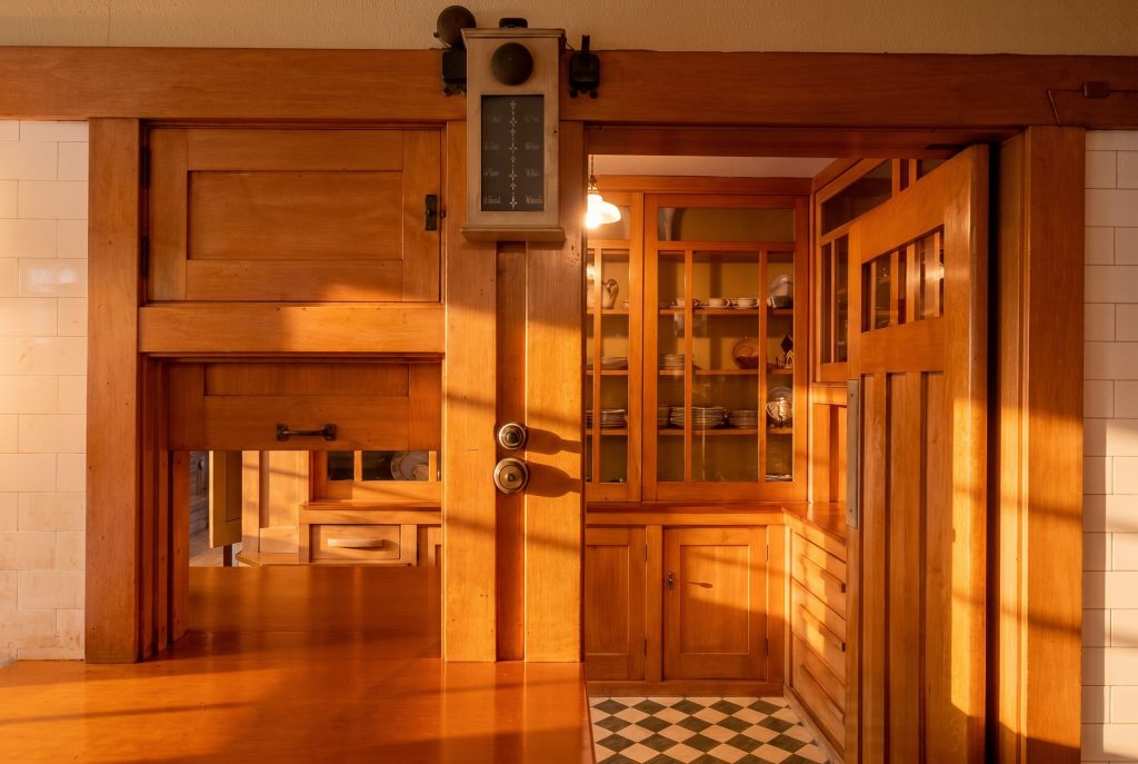 Built-in maple cabinetry and pale sugar pine countertops along the kitchen wall of the David B. Gamble House, plainly detailed working surfaces rather than decorative woodwork