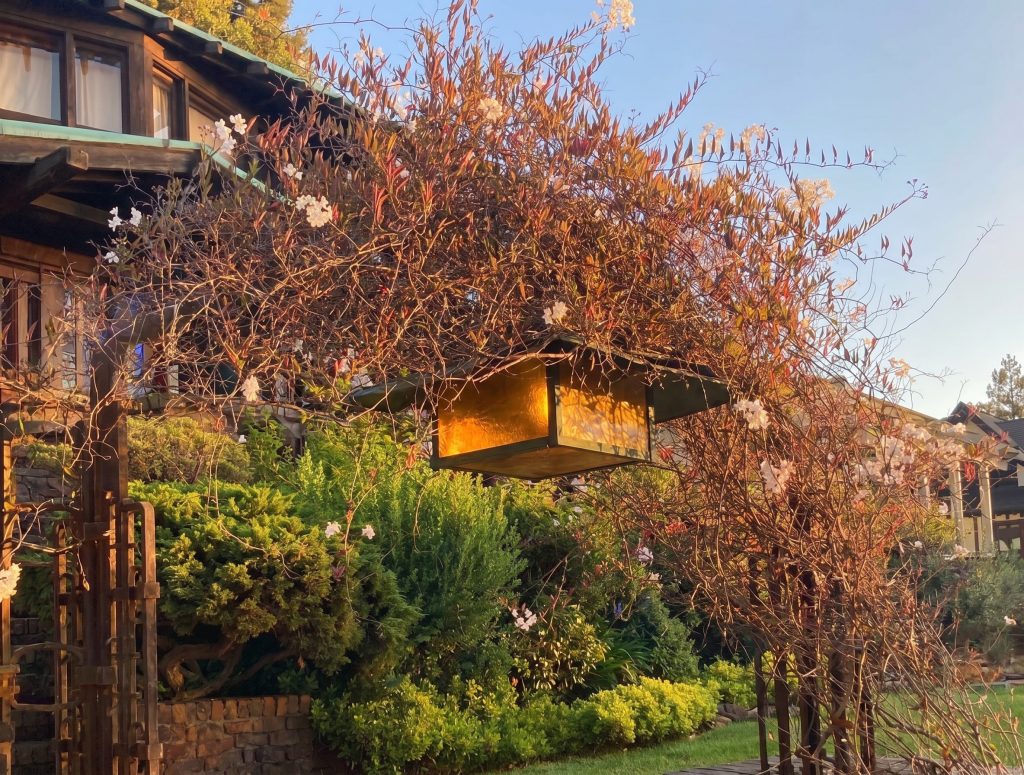 Hanging lantern at the Thorsen House entrance gate with amber art glass and wrought-iron frame