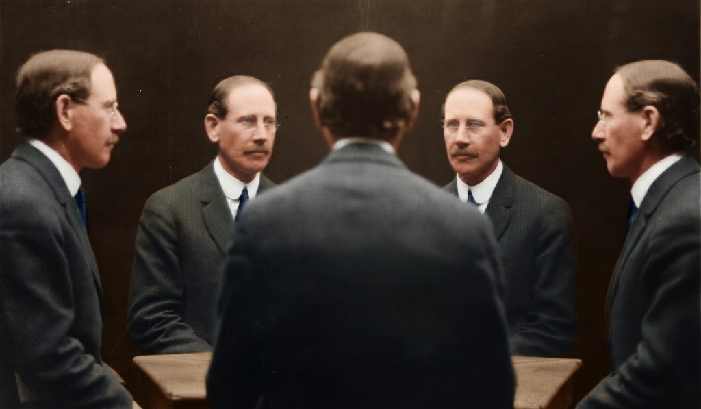 Colorized historic multi-view portrait photograph showing five views of a single bespectacled man in a dark suit and white collared shirt, photographed simultaneously from front, profile, and three-quarter angles using a mirrored studio setup, with the subject's back visible at center